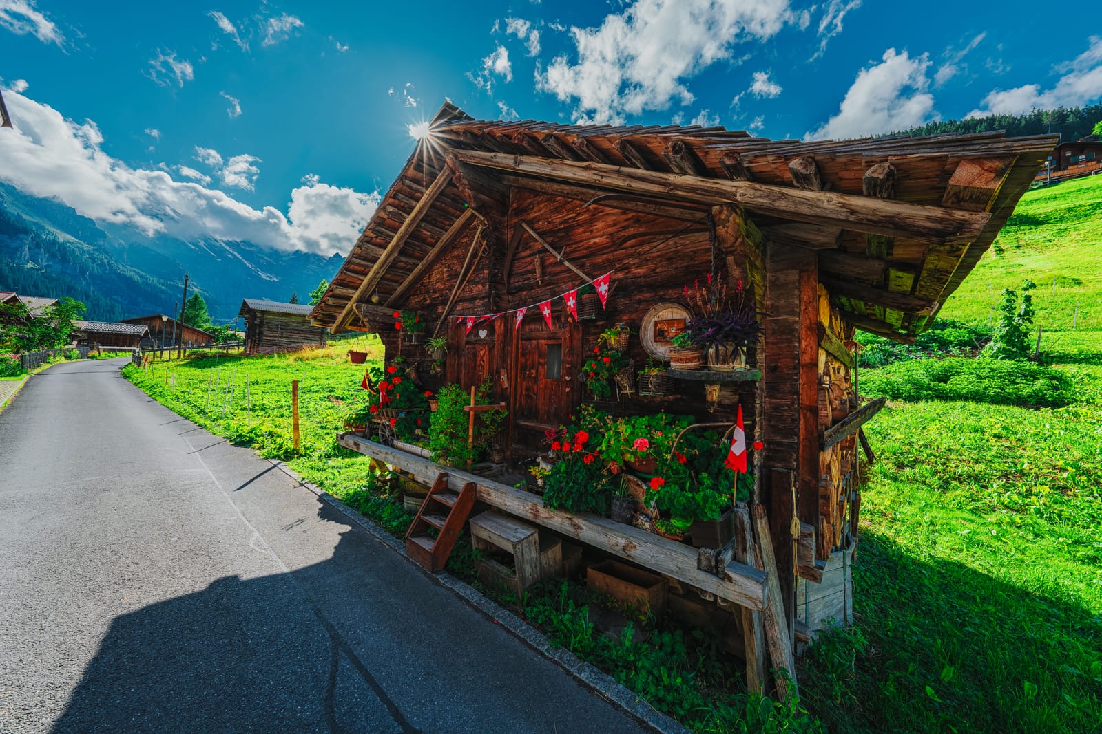 Flower-covered wooden roadside stand on an alpine road.